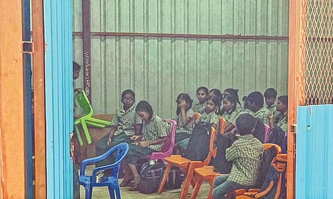 The temporary metal sheds inside the nearby school premises where some students have their classes.