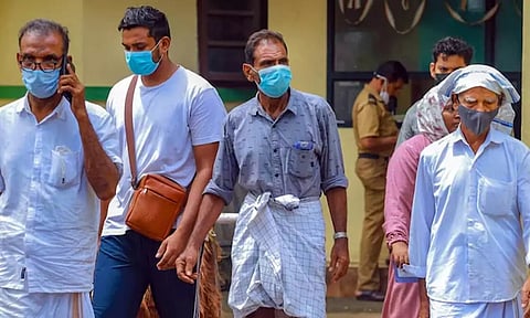 People wear masks at a medical college after the Nipah virus alert in Kozhikode. (PTI)&nbsp;