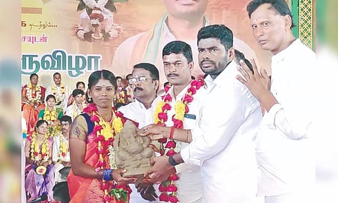 BJP state president K Annamalai presenting a statue of Vinayagar to a couple in Coimbatore on Sunday