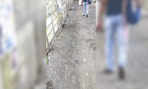 After authorities removed the newly laid tiles on Pallavaram railway station foot over bridge, the commuters are now forced to walk on rough surface
