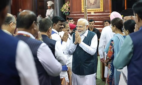 Prime Minister Narendra Modi greets Parliamentarians during the special event at Central Hall. (ANI)