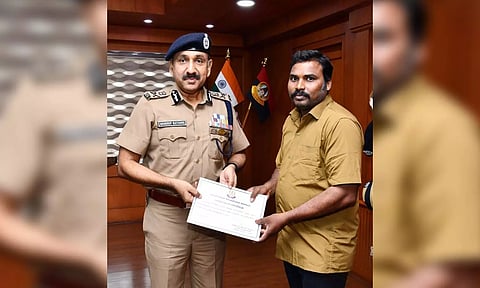 GCC Commissioner Sandeep Rai Rathore felicitates auto driver Magesh.&nbsp;