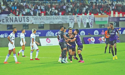 Odisha players celebrate a goal against Chennaiyin FC