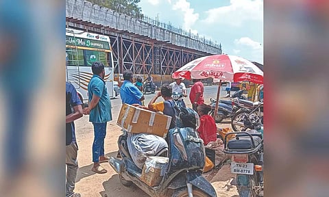 Men with meat packed in boxes wait for Chennai-bound bus in Ambur