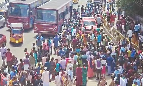 Commuters waiting on GST Road after EMU services were cancelled on Sunday