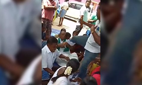 Video grab of panchayat secretary J Thangapandian kicking a farmer at Pillaiyarkulam gram sabha meeting in Virudhunagar on Monday