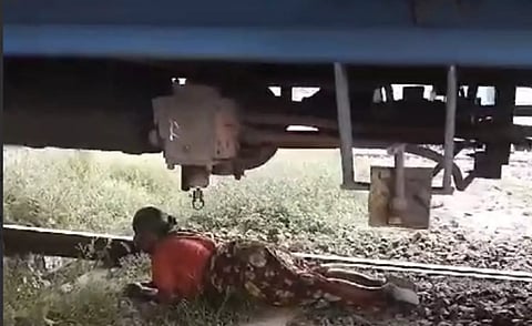 Screengrab of woman beneath the good train in Manapparai near Tiruchy