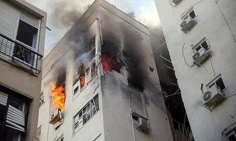 A building is ablaze following rocket attacks from the Gaza Strip, in Tel Aviv..(Reuters)