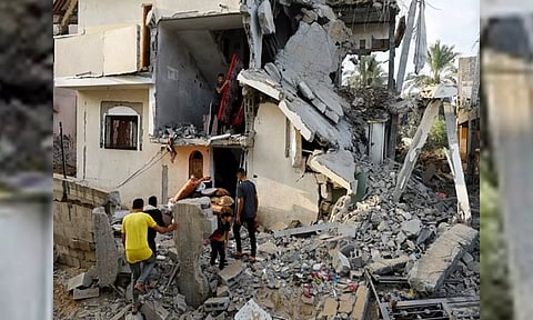 Palestinians carry out belongings from a damaged house in Gaza Strip (ANI)