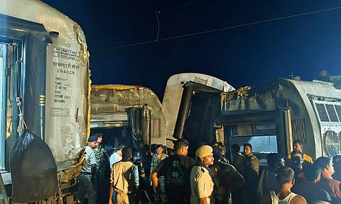 Police and locals at the site of the accident after six bogies of North East Express derailed near Raghunathpur railway station in Buxar district, on Wednesday night. (PTI)