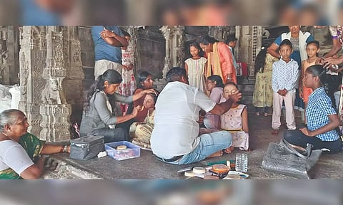 Children being readied for a dance performance, which was conducted without a stage, inside the fort.