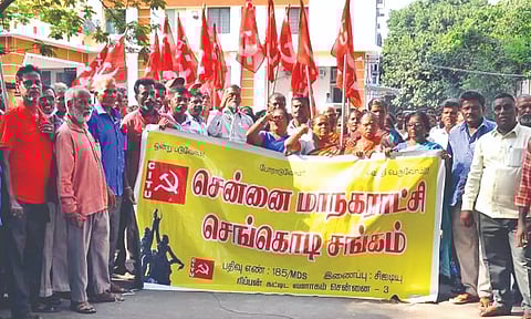 Workers affiliated to Red Flag union staging a protest outside Chennai Corporation office on Wednesday.
