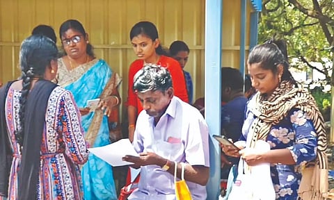 Investors, who ‘lost’ money in the monthly gold chit scheme run by a jewellery chain, gather outside its shop in Chromepet.