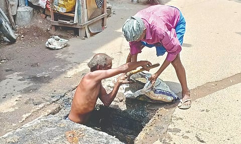 Workers cleaning a sewer manually. (File)