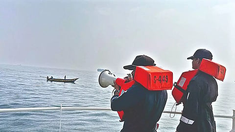 Coast Guard warning fishermen in the sea off Chennai.