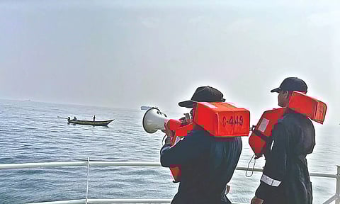 Coast Guard warning fishermen in the sea off Chennai.