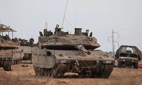 An Israeli tank and military vehicles are seen near Israel's border with the Gaza Strip, in southern Israel (Photo: Reuters)