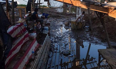 People sit under a damaged structure in the aftermath of Hurricane Otis near Acapulco, Mexico (Photo: Reuters)