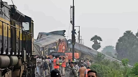 Rescue workers and police officials stand next to damaged coaches following a collision between two passenger trains in Vizianagaram district of Andhra Pradesh (Photo/Reuters)
