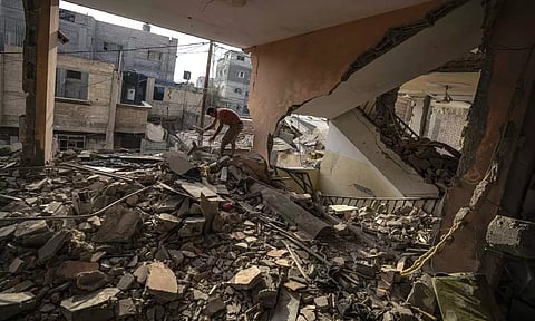 A Palestinian checks the destruction after Israeli strikes on the Gaza Strip in Khan Younis. (AP)