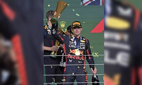 Max Verstappen atop the podium after winning the F1 Brazil GP