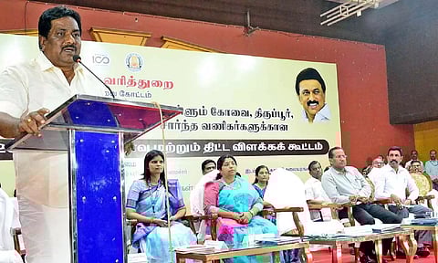 Minister P Moorthy addressing a traders’ meeting in Coimbatore on Tuesday