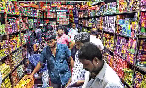 People buy crackers in Island Ground shops ahead of Deepavali