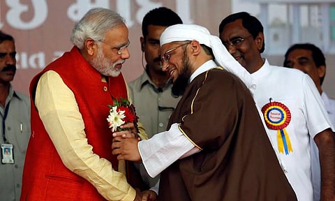 PM Narendra Modi receives flowers from a Muslim cleric after the inauguration of a hospital in Ahmedabad (Photo: Reuters)