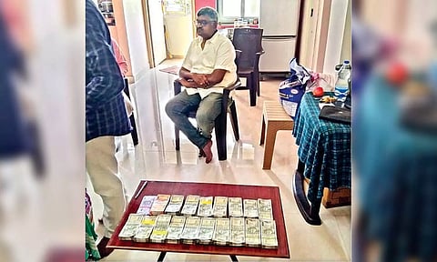 Arrested Suresh Babu with seized cash
