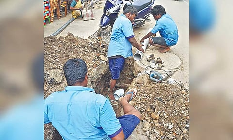 Workers repairing the sewage connection works
