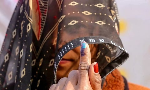 A female voter in veil shows her finger marked with indelible ink after casting a vote (ANI)&nbsp;