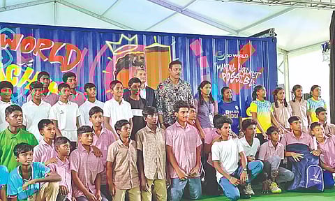 Ravi Shastri poses with the school students with their newly distributed cricket kits at the ICC Beyond Boundaries event