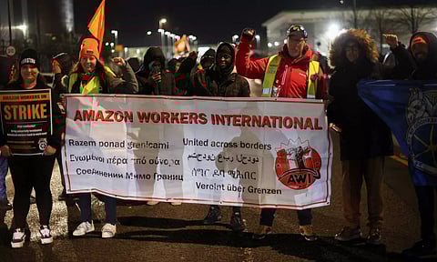 People hold a banner during a Black Friday strike outside the Amazon warehouse, in Coventry, Britain (Photo: Reuters)