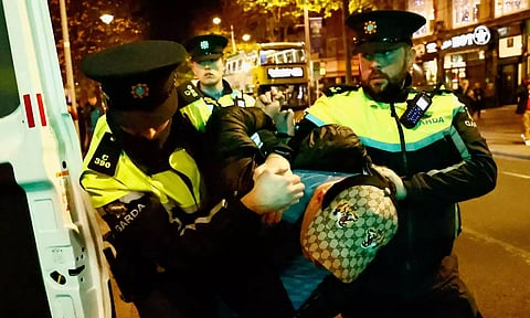 Members of the Garda Public Order Unit detain a man, following a riot in the aftermath of a school stabbing that left several children and adults injured on O'Connell Street, in Dublin (Photo: Reuters)