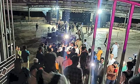 People gather near the area at Cochin University where a stampede killed at least four students and left several injured during the anniversary celebrations, in Kochi. (PTI)
