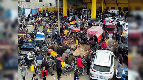 Palestinians wait to fill their cars with fuel (Photo Credit: Reuters)