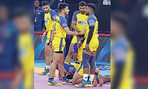 Tamil Thalaivas players celebrate after winning a point