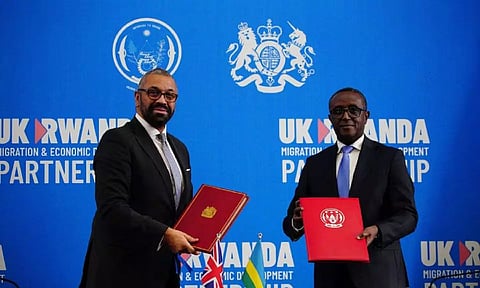 British Home Secretary James Cleverly and Rwandan Minister of Foreign Affairs Vincent Biruta sign a new treaty, in Kigali, Rwanda (Reuters)