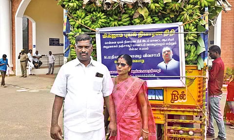 Madhiazhagan and wife Kavitha with truck load of bananas in Thanjavur on Monday