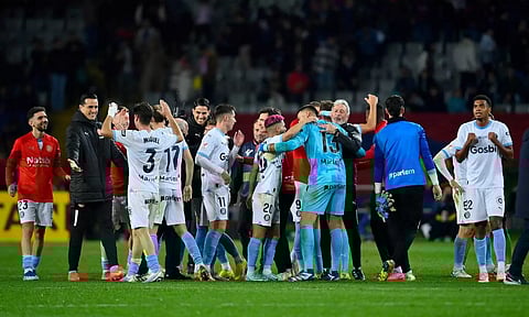 Girona FC players celebrate their victory against FC Barcelona