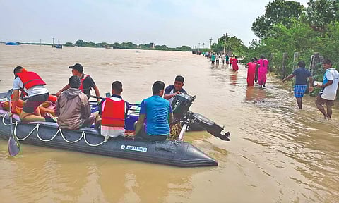 NDRF team rescuing people using boats in Thoothukudi.