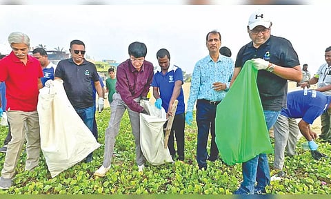 GCC commissioner Radhakrishnan participates in a beach clean-up drive at Besant Nagar on Saturday.