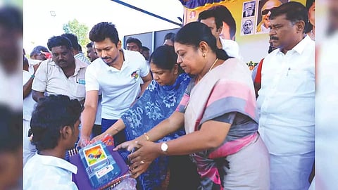 Minister Udhayanidhi Stalin and Kanimozhi, MP, distributing relief material to a flood victim in Thoothukudi on Monday
