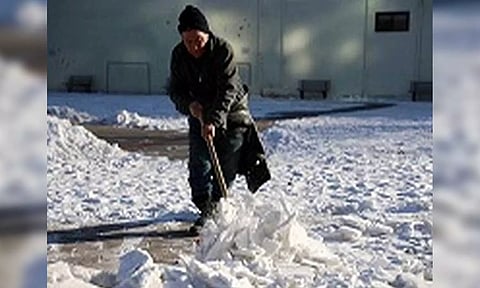A worker clears the heavy snow at a park in Beijing, China (Reuters)