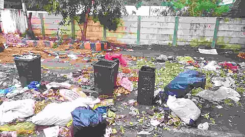 Uncleared garbage scattered on the road at Evening Bazaar Road in Parrys