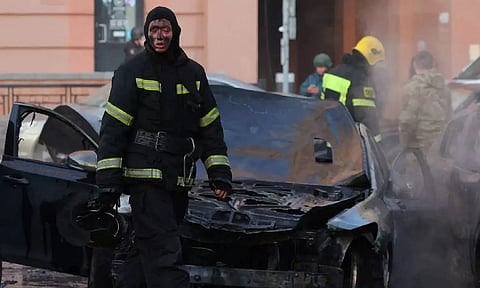 A firefighter takes a pause as he works to extinguish burning cars following what Russian authorities say was a Ukrainian military strike in Belgorod (Reuters)