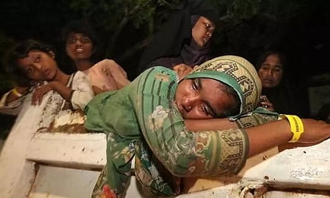A Rohingya Muslim woman reacts while on a truck in Indonesia (Reuters)