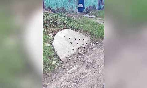 A recharge well half buried under the newly-laid road in the area