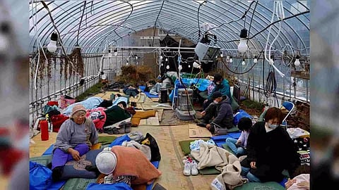 Evacuated people rest at a green house converted as an evacuation center, in the aftermath of an earthquake (Reuters)
