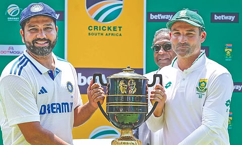 Rohit Sharma and Dean Elgar pose with the trophy